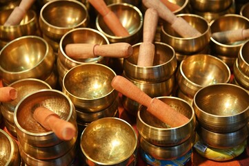 Bunch of piled Hinduist tibetan singing bowls for wellness practices