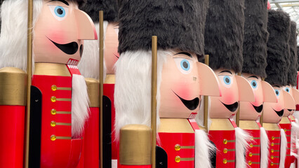 Giant nutcracker figurines in red soldiers' coats paraded for christmas