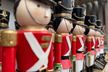 Fototapeta na wymiar Giant nutcracker figurines in red soldiers' coats paraded for christmas
