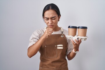 Young hispanic woman wearing professional waitress apron holding coffee feeling unwell and coughing...