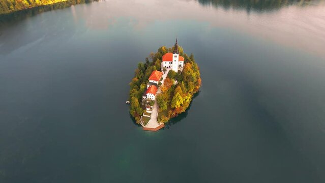 Elevated view of a colourful autumn sunrise at Lake Bled with the Pilgrimage Church of the Assumption of Maria on a small island, Upper Carniola, Triglav National Park, Bled, Slovenia