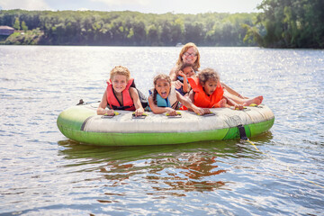 Smiling family tubing on an inland lake