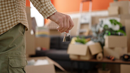 Middle age man holding key standing at new home