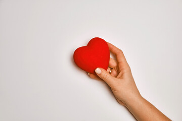 hands holding red heart, health care, love, organ donation, mindfulness, wellbeing, family insurance and CSR concept, world heart day, world health day, world mental health day, praying concept