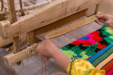 tapestry weaving process on a traditional wooden handloom