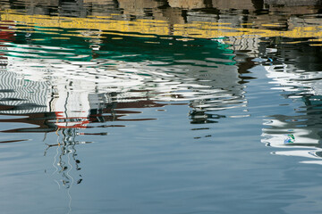 Nautical vessels reflected on water. Iceland