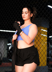 Indian Boxer Girl with Hand Wraps preparing for a kick boxing training and workout session.