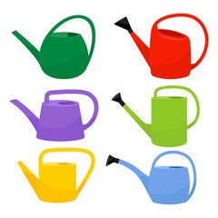 A set of colored garden watering cans for watering the garden, vegetable garden, flowers and plants. © miss LEMON