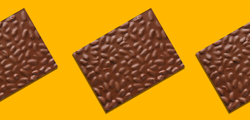 Milk chocolate almond bars against yellow background and Pattern
