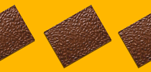 Milk chocolate pistachio bars against yellow background and Pattern