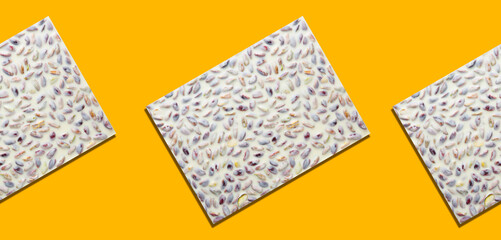 White chocolate pistachio bars against yellow background and Pattern
