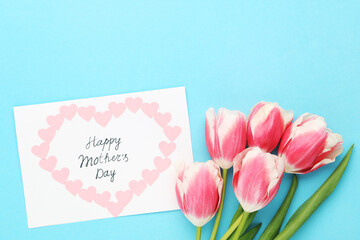 Text Happy Mother's Day with tulip flowers on blue background