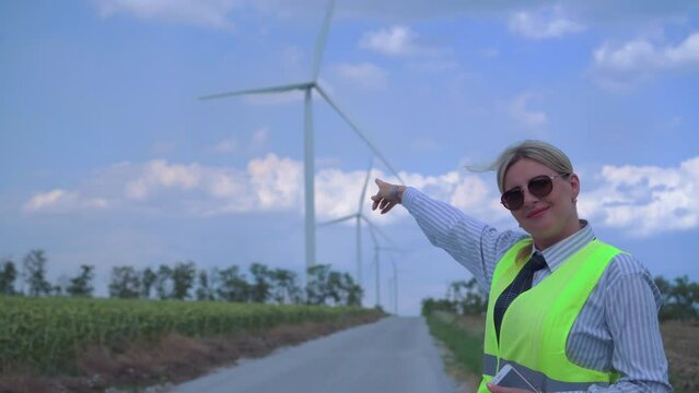The woman, a specialist in servicing and troubleshooting wind turbines, points to the result of her work.