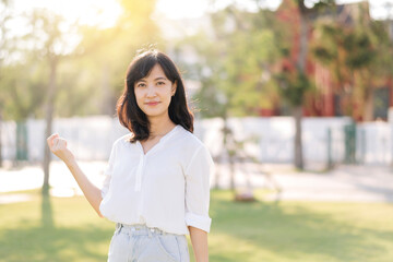 Portrait young beautiful asian woman with happy smile around outdoor park in sunny summer day