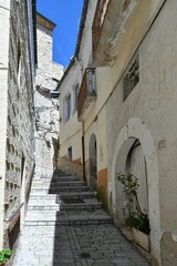 Fototapeta na wymiar A narrow street among the old houses of Pietramontecorvino, a medieval village in the state of Puglia in Italy.