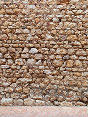 Old wall of stone and mud. Rustic stone facade. Constructions and Architecture.