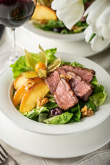 Salad with caramelized apples and duck fillet breast