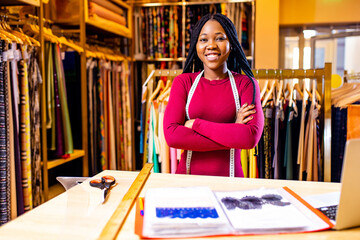 dark skinned business woman salewoman working at textile shop
