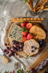 Cheese board with fruits and grissini