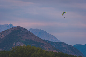 A paraglider in the French Alps during the sunset