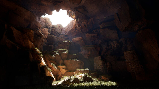 The old cave in the mountais with a light from the top hole