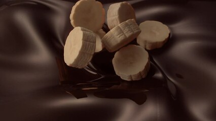 banana slices pouring into swirling liquid chocolate mixture - Powered by Adobe