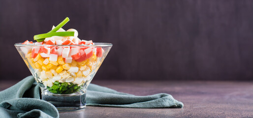 Delicious vegetarian salad of crab sticks, eggs, onion and corn in a bowl web banner © elenarui