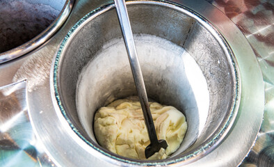 Turkish Maras metal ice cream bowl in front of an ice cream parlor. Maras ice cream is known for...