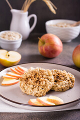 Apple crumble pancakes and fresh apples on plate. Homemade desserts. Vertical view