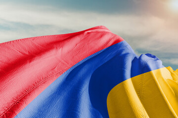 Armenia national flag cloth fabric waving on beautiful grey background.