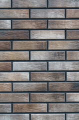 Texture of a wall made of new grey-brown bricks.
