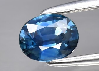 Natural gemstone blue sapphire on gray background