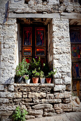 Fototapeta na wymiar Vacation destination Chios / Greece: House facade with colorful door in the picturesque village of Volissos in the north of the Greek Aegean island. Attractive vacation destination, with less tourists