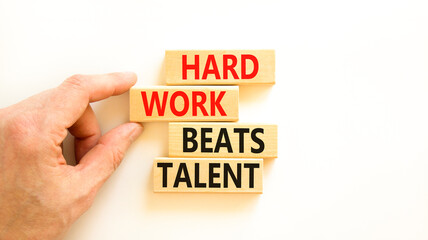 Hard work beats talent symbol. Concept words Hard work beats talent on wooden block. Beautiful white table white background. Motivational business hard work beats talent concept. Copy space.