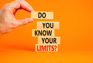 Do you know your limits symbol. Concept words Do you know your limits on wooden block. Beautiful orange table orange background. Businessman hand. Business do you know your limits concept. Copy space.