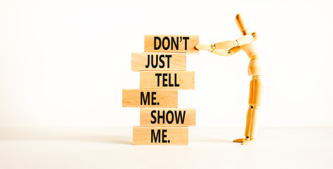 Tell or show symbol. Concept words Do not just tell me, show me on wooden blocks. Beautiful white...