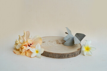 Minimal modern product display podium on neutral background with wooden podium, tropical summer flowers