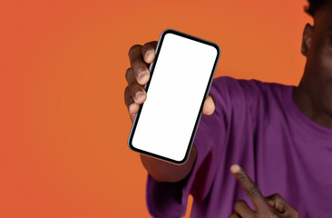 Black man holding cell phone with blank screen, mockup