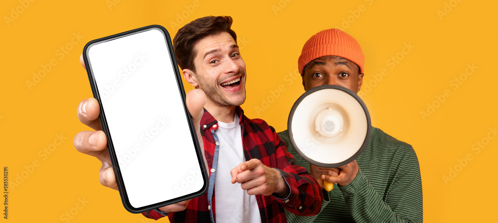 Poster two cheerful guys making announcement with megaphone and showing blank smartphone
