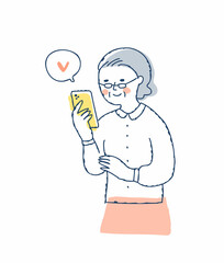 スマホを見ているシニア女性