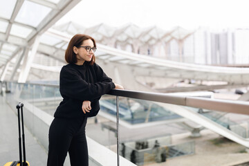 Portrait Of Smiling Young Woman Standing At Airport Terrace