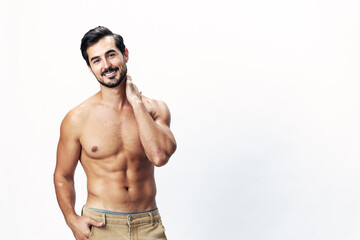 Fototapeta premium Male athlete model with naked torso and packs of abs sporty on white isolated background, trendy clothing style, copy space, space for text