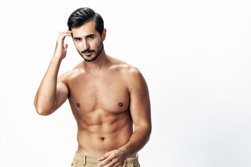 Fototapeta premium Male athlete model with naked torso and packs of abs sporty on white isolated background, trendy clothing style, copy space, space for text