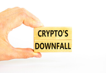 Crypto downfall symbol. Concept words Cryptos downfall on wooden blocks. Beautiful white table white background. Businessman hand. Business and crypto downfall concept. Copy space.