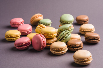 Sweet colorful macarons dessert on a gray background