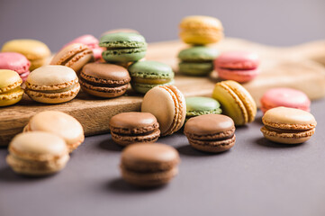 Sweet colorful macarons dessert on a gray background