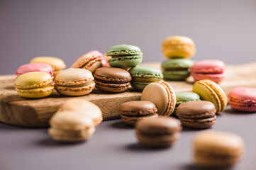 Sweet colorful macarons dessert on a gray background