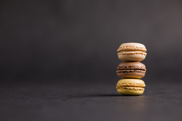 Sweet colorful macarons dessert on a black background