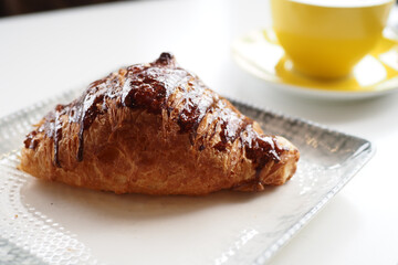 fresh baked croissant on plate with copy space 