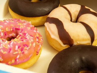 An assortment of delectable miniature doughnuts, coated with chocolate and colorful frosting